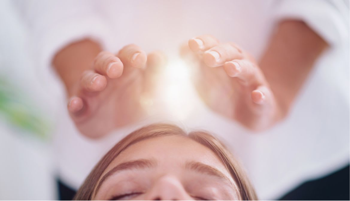 Reiki healing session with hands channeling universal energy, love, on Ad Astra Healing website.